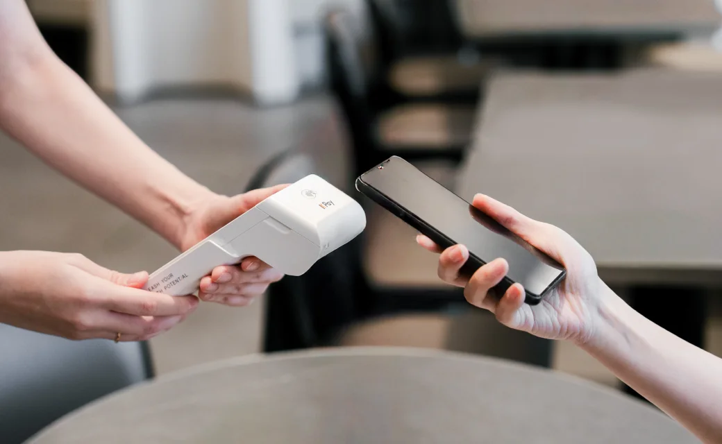 A customer pays by phone on a KPay Terminal Pro