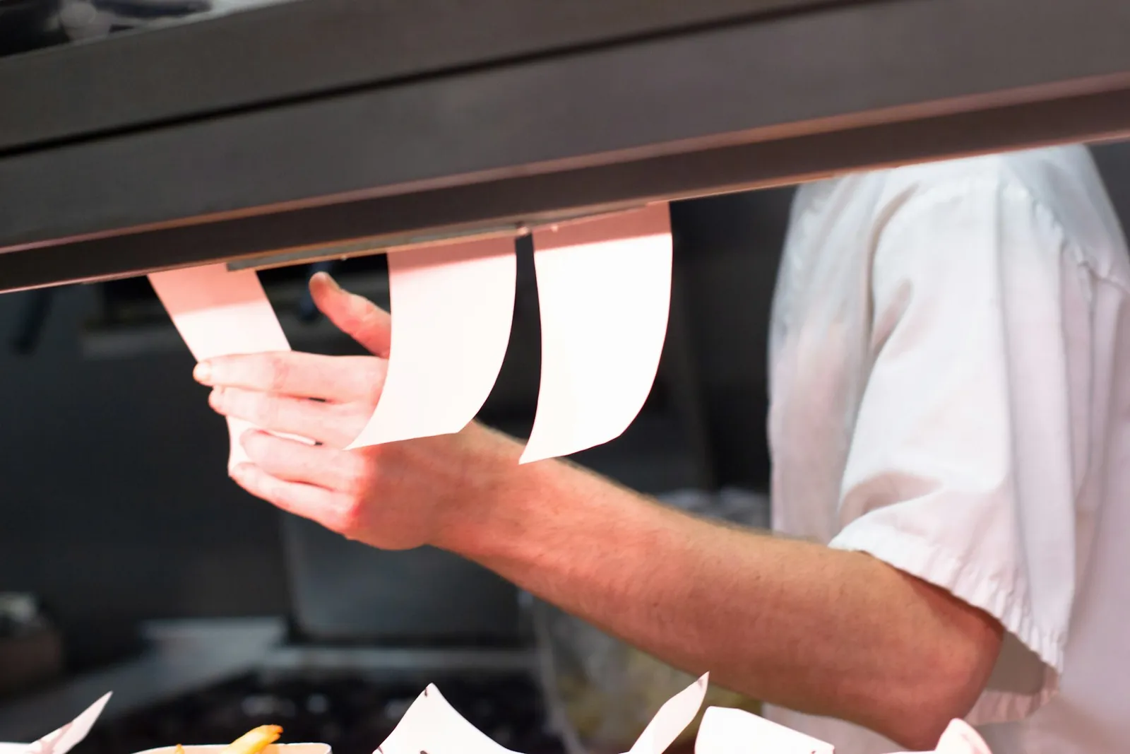 Order dockets on the rail in a restaurant kitchen